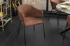 A brown upholstered dining chair with a black metal frame is shown in a room with dark wooden floors. Produktbild-Vorschau