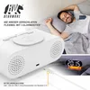 A man is sleeping peacefully in bed next to a digital alarm clock. The clock is white and has a wireless charging pad on top. The image also shows a close-up of the clock's charging port and a digital display showing the time. Anteprima dell’immagine prodotto