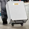 A person is pulling a rolling tool case. Náhled obrázku produktu