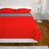 A red and gray quilt is laid out on a bed with two pillows. Podgląd zdjęcia produktu
