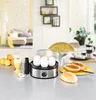A breakfast scene featuring an egg boiler and boiled eggs, with bread rolls and oranges in the background. Produktbild-Vorschau