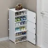 A white modular shoe rack filled with various shoes, with a brown handbag on top, placed next to a white door. Náhľad obrázku produktu