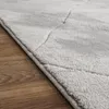 A close-up view of a gray rug with a geometric pattern, placed on a wooden floor. Anteprima dell’immagine prodotto