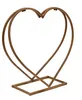 A metal heart-shaped firewood rack on a white background. Produktbild-Vorschau