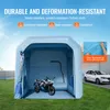 An inflatable car/motorcycle garage with a motorcycle inside, parked on grass next to a white car. Voir les images du produit