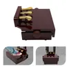 A piano pedal extender bank with three gold pedals on a dark brown wooden base, shown from different angles including one with a foot pressing a pedal. Náhled obrázku produktu
