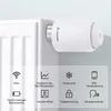 A smart thermostat attached to a radiator, with icons and text describing its features. Podgląd zdjęcia produktu