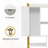 Close-up view of a white bookshelf with a gold frame, showing an open door with a magnetic closure and a safety warning symbol. Podgląd zdjęcia produktu