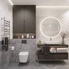 A modern bathroom with a wall-mounted toilet, vanity with sink, and a large illuminated mirror. Voir les images du produit