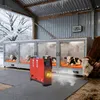 Calves in heated enclosures in a barn during winter, with a diesel heater in the foreground. Náhled obrázku produktu