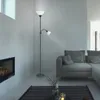 A modern living room with a fireplace, sofa, and a floor lamp. Produktbild-Vorschau