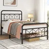 A black metal bed frame with bedding is shown in a bedroom setting. Produktbild-Vorschau