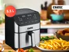 An air fryer is shown on a kitchen counter with french fries and chicken wings. Produktbild-Vorschau