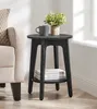 A black round side table with a plant and a mug on top, placed next to a beige sofa. Produktbild-Vorschau