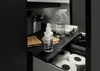 A cleaning product and supplies are neatly organized in a cabinet or drawer. Produktbild-Vorschau