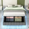 A bed with storage underneath, in a room setting with a bedside table and a round table. Náhľad obrázku produktu
