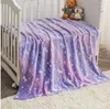 A fluffy blanket with a unicorn and star pattern is draped over a crib. Two teddy bears are sitting on the blanket. Náhľad obrázku produktu