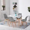 A dining set with a white table and four gray chairs is arranged on a rug in a well-lit room. Voir les images du produit