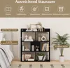 A black bookshelf filled with decorative items and books, placed next to a bed and a potted plant. Podgląd zdjęcia produktu