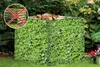A privacy screen with a green ivy pattern is shown in a garden setting, with a red 'X' symbol overlay on a wooden compost bin in the top-left corner. Produktbild-Vorschau