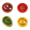Four different fruits and vegetables are shown in individual colorful containers. Produktbild-Vorschau