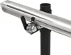 A close-up view of a stainless steel grill spit with a motor and rollers, mounted on a black pole. Produktbild-Vorschau