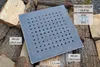 A square metal grate with many holes is placed on a pile of chopped wood. Produktbild-Vorschau