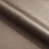 A close-up, angled view of a folded piece of brown fabric. Produktbild-Vorschau