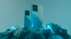 Two smartphones are displayed on a textured, abstract surface with blue lighting. Náhled obrázku produktu