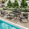 A patio furniture set is arranged on a wooden deck next to a swimming pool, with a lush garden and house in the background. Anteprima dell’immagine prodotto
