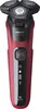A studio shot of a red and black electric shaver against a white background. Náhľad obrázku produktu