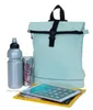 A backpack, water bottle, and soda can are displayed on a yellow magazine with a tablet on top. Produktbild-Vorschau