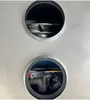 A close-up view of two circular openings in a gray metallic surface, revealing internal components of a heat pump. Produktbild-Vorschau