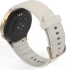 The back of a smartwatch with a white strap and gold accents is shown against a white background. Voir les images du produit