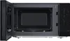 The interior of a black microwave oven with the door open. Produktbild-Vorschau