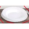 Two white plates stacked on a wooden surface. Anteprima dell’immagine prodotto