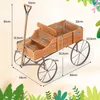 A wooden wagon planter with dimensions labeled. Voir les images du produit