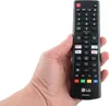 A hand holding a black LG remote control. Podgląd zdjęcia produktu