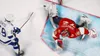 A hockey player in a white and blue uniform is skating towards a goalie in a red and black uniform who is diving to make a save in front of a net. Produktbild-Vorschau