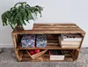 A wooden crate shelf unit with decorative boxes, books, and a plant. Náhled obrázku produktu