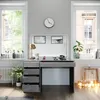 A vanity table with drawers and a mirror, set in a well-lit room with windows and a radiator. Produktbild-Vorschau