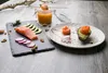 A prepared meal with salmon, avocado, radishes, and a dipping sauce. Produktbild-Vorschau
