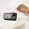 A woman sleeping in bed next to a projection alarm clock. Anteprima dell’immagine prodotto