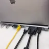 A close-up view of a laptop docking station with various cables plugged in. Produktbild-Vorschau