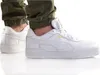 A person wearing white Puma sneakers and green pants. Produktbild-Vorschau