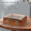 A retro-style CD phonograph sits on a wooden table, with decorative text overlaying the background. Produktbild-Vorschau