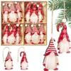 A collection of Christmas gnome ornaments in a wooden box and hanging from a tree branch. Náhled obrázku produktu