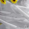 A close-up view of a sheer gray curtain with a subtle pattern, featuring two yellow sunflowers in the upper left corner. Produktbild-Vorschau