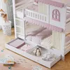 A white bunk bed with pink accents, featuring storage drawers and a playhouse-like design. Anteprima dell’immagine prodotto