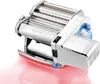 A chrome-plated electric pasta maker with blue accents is shown against a white background with a pinkish reflection. Podgląd zdjęcia produktu